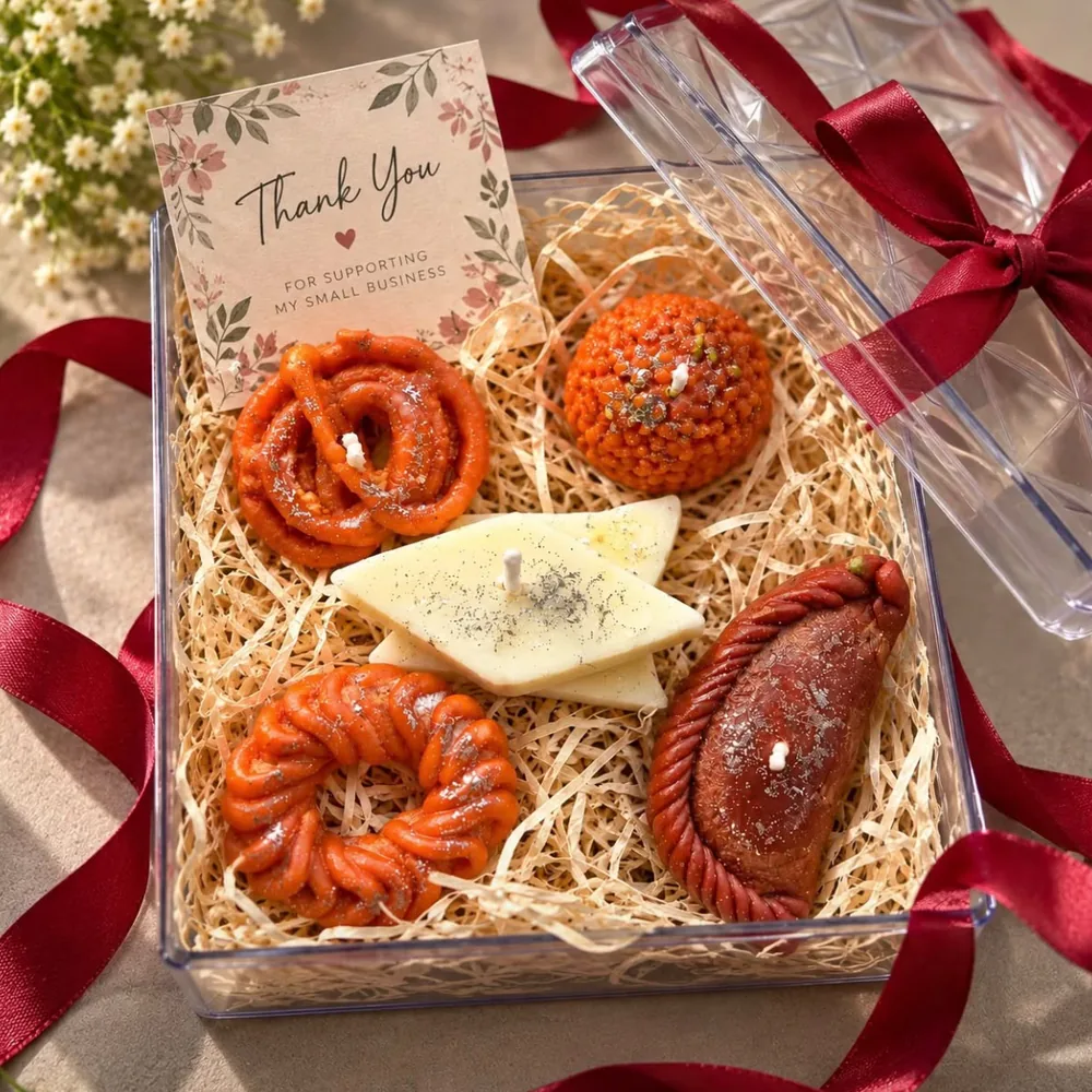 Sweets candle hamper in a clear acrylic box with jalebi, laddoo, kaju katli and gujiya candles