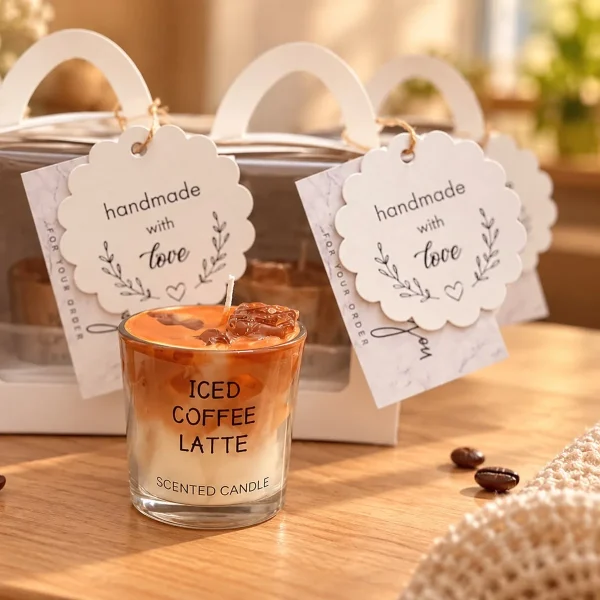 Iced coffee latte soy candle in a glass labelled Iced Coffee Latte, next to white gift boxes with handmade-with-love tags