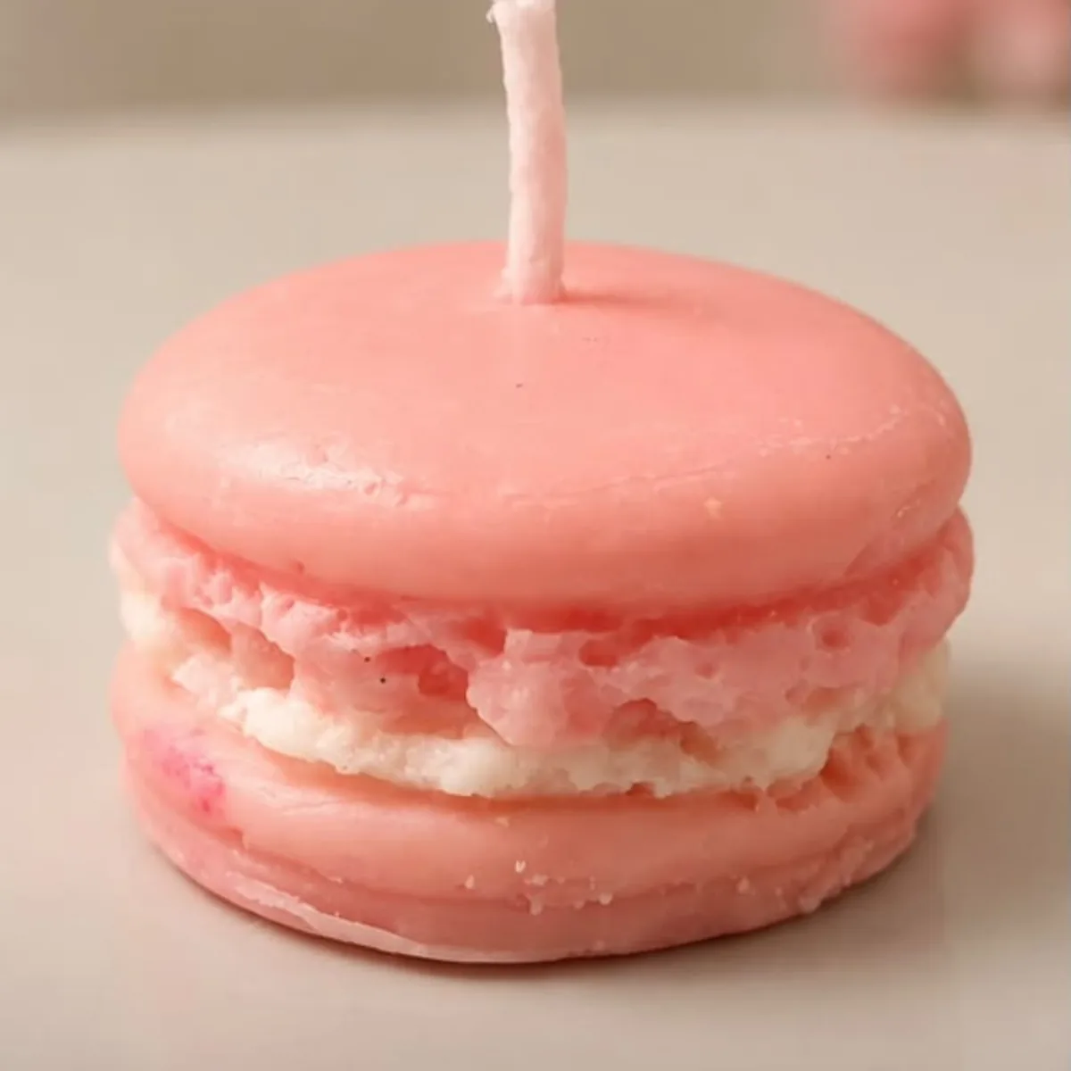 Pink macaron soy candle with a creamy filling layer
